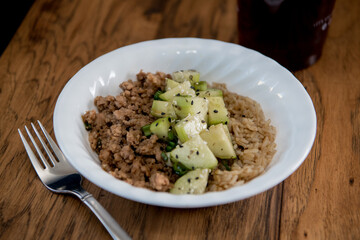 brown rice bowl with ginger ground pork and cucumbers
