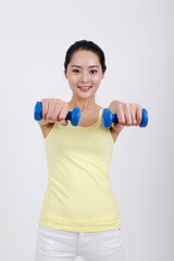 A young lady holding a blue dumbbell 