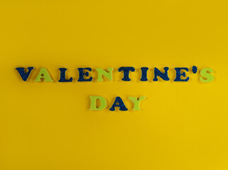 Valentine's Day glitter sign text on pastel yellow background copy space, creative flatlay minimal style concept. Love greeting card top view social media sale banner design. Bright vebrant colors.