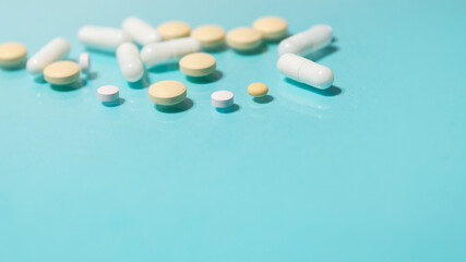 close up. various tablets on a blue sheet of paper.