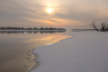 On the thin ice. Sunset over the river.