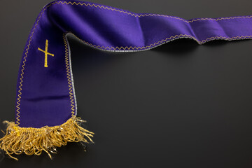 Purple violet priest's stole on a black background