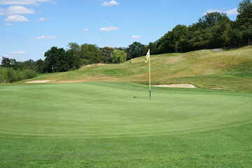 Detail of well maintained golf green with flag, golf concept