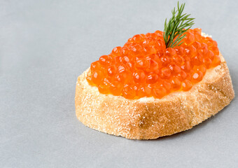 Sandwich with fresh grainy red salmon caviar