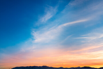 Beautiful panoramic sunset over the mountains silhouette.
