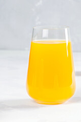 Orange juice in glass on white background. Helthy food and drink. Vegan diet. Fresh juice