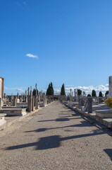 A beautiful view of a cemetery graveyard with tombstones crosses and angels at llucmajor in mallorca island balearic spain on a clear sunny day 