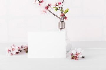 White empty card mockup with blooming almond tree branch. Valentine's Day card for your love