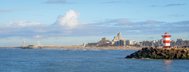 Panoramic view over Scheveningen Pier, beach, and harbor entrance with lighthouse