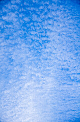 Blue sky background with abstract white clouds