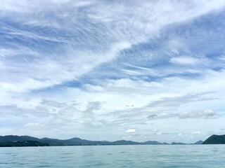 The landscape of the sea, the beautiful sky with many shapes of could, clearly mangrove sea, forest, fish cage and island in relax mode, Phuket Thailand.