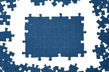 blue puzzle pieces on a white background, assemble a puzzle, concept of hard work on a complex...