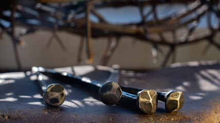 Bloody nails against image of crown of thorns as symbol of passion of Jesus Christ. Horizontal...