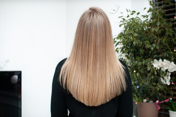 Blonde hair with streaked strands on young woman