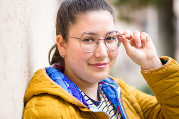 Cute girl with eyeglasses and with face skin problems. Outdoor photo