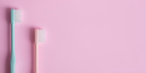 toothbrush in pastel colors on pink background .copy  space  .banner.