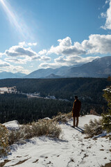 Man looking at view from mountain top