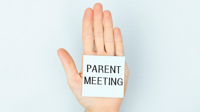 Adhesive Paper On The Palm Of The Hand With The Text Parent Meeting