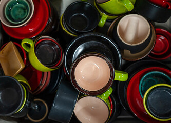 Many colorful ceramic or pottery cups, top view