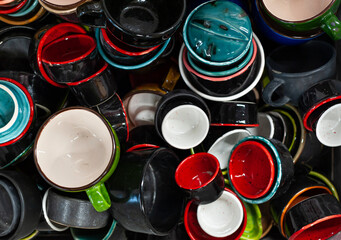 Many colorful ceramic or pottery cups, top view
