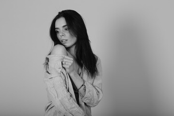 Black and white studio portrait of beautiful young brunette woman