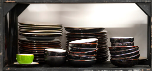 Stacks of craft ceramic or pottery plates on a shelf
