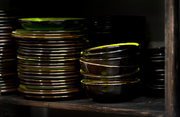 Stacks of craft ceramic or pottery plates on a shelf
