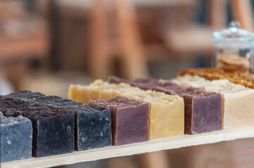 Colorful bars of handmade organic soap on a shelf