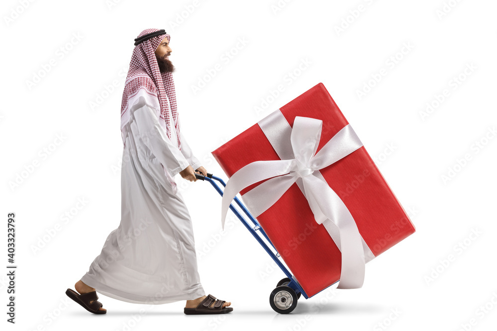 Wall mural Saudi arab man pushing a hand truck with a big wrapped present box