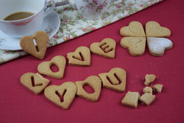 I love you too, inscription with cookies, drunk coffe, lipstic on cup, crumbs, red background, z humorem walentynki