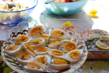 Traditional Swedish smorgasbord during Easter holiday with healthy boiled eggs cut in half, decorated with some fresh dill.