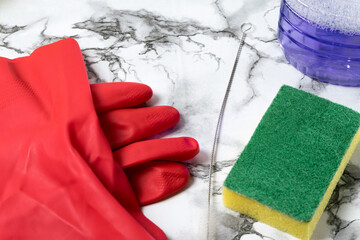 person cleaning objects and table and cleaning supplies