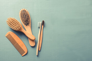 Body care with eco-friendly accessories. Bamboo toothbrushes and combs. - obrazy, fototapety, plakaty