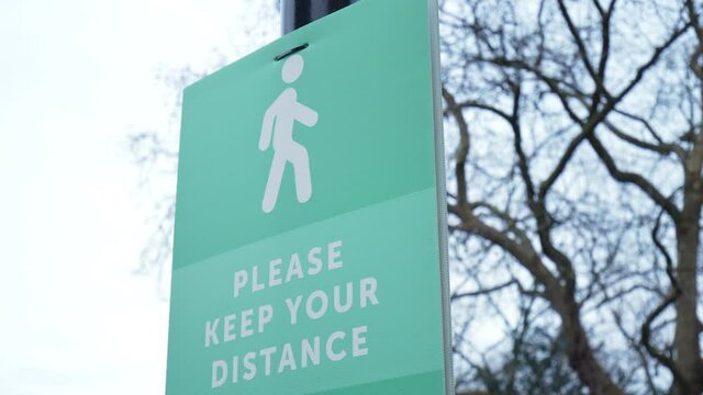 Please keep your distance board on the outdoor streets in 4K. social distancing measures during Coronavirus COVID-19 Pandemic.