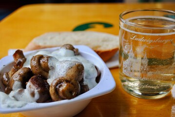 LUDWIGSBURG, GERMANY: Barock-Weihnachtsmarkt (Baroque Christmas Market) gluwein (warm mulled wine) mug, mushrooms and garlic white sauce. 