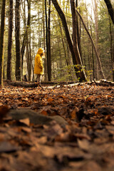 woman wearing yellow jacket in the forest