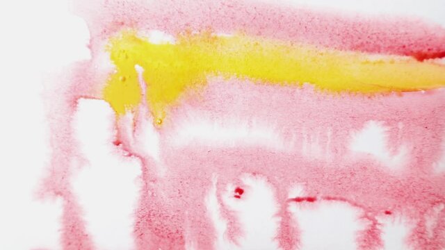 brush strokes of watercolor red and yellow paint with stains on a sheet of white paper.