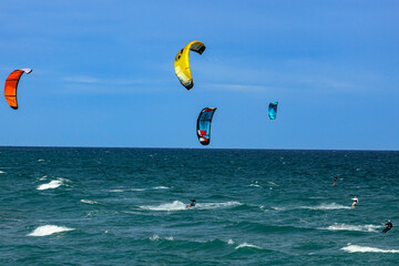 Kite surfing on a windy day offshore in Juno Beach Florida. © Joe Ciciless