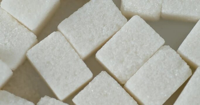 Sugar cubes on the table slowly rotate. 