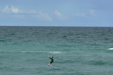 Fototapeta na wymiar Kite surfing on a windy day offshore in Juno Beach Florida.