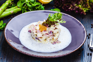 Octopus tartare with pike caviar on a plate