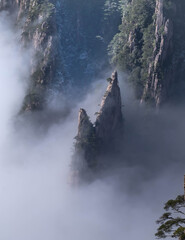 View of the clouds and valley of the mountain peak at the Huangshan National park, China. Landscape of Mount Huangshan of the winter season. UNESCO World Heritage Site, Anhui China.