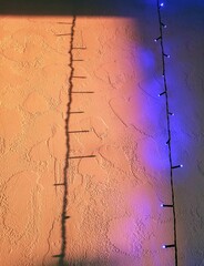 shadow from a garland on an orange wall