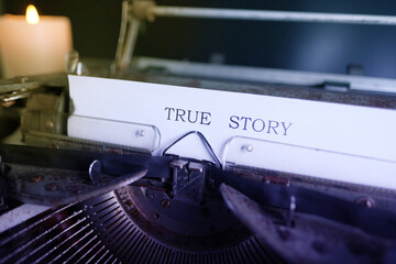 old typewriter on table, words true story are printed on paper in large size, retro style, concept of writer, journalist, private detective