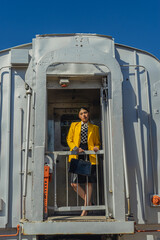 Young girl in vintage clothes at old train station