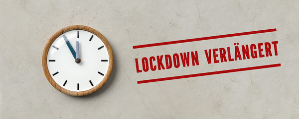 clock and  German message for LOCKDOWN EXTENDED on paper background