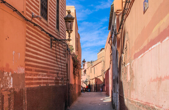 Traditional narrow reddish brown street of Marrakech Medina