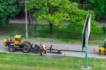 Men at work. Workers are repairing the asphalt.