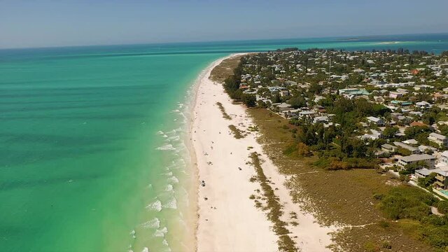 Aerial view of the turquoise water and the beach of Anna Maria Island in Florida.