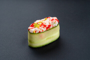 Single cucumber tobiko on black background